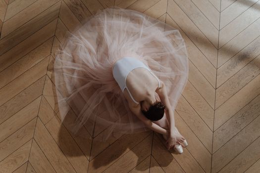 Woman in White Dress Lying on Brown Wooden Floor