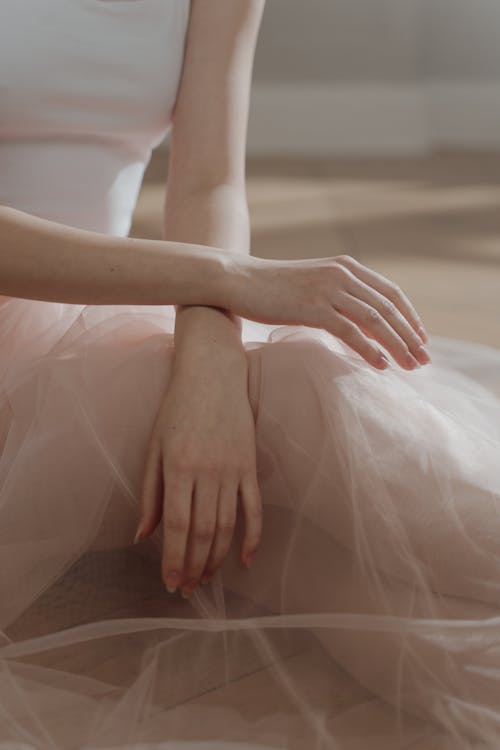 Close-up Photo of Person's Hand resting on a Sheer Fabric 