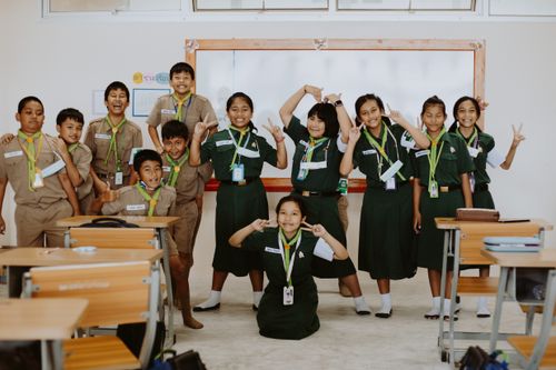 Free Group of Thai students in uniform posing happily in their classroom, reflecting friendship and joy. Stock Photo