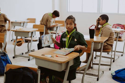 Children in classroom wearing uniforms, engaged in lessons, showcasing diversity and education.