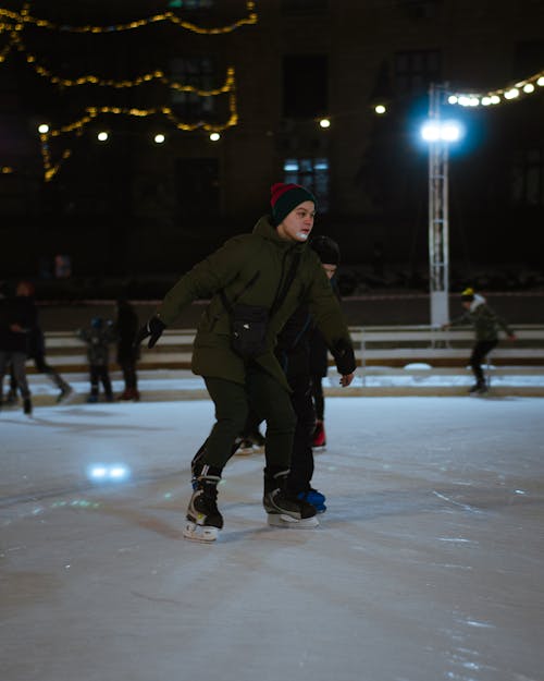 People Skating on the Rink During Night Time