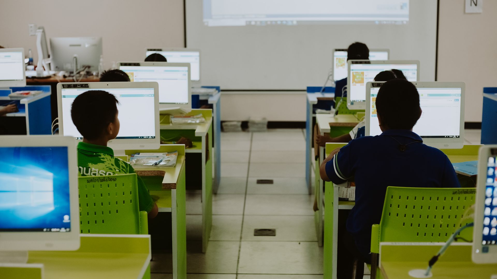 School students using computers in a classroom that needs electrical test and tag compliance