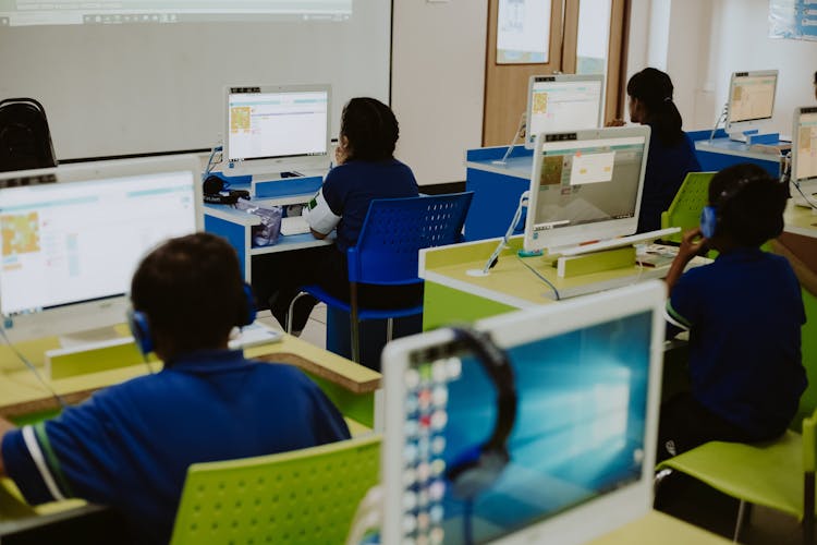 Students Using Computers In Their Class