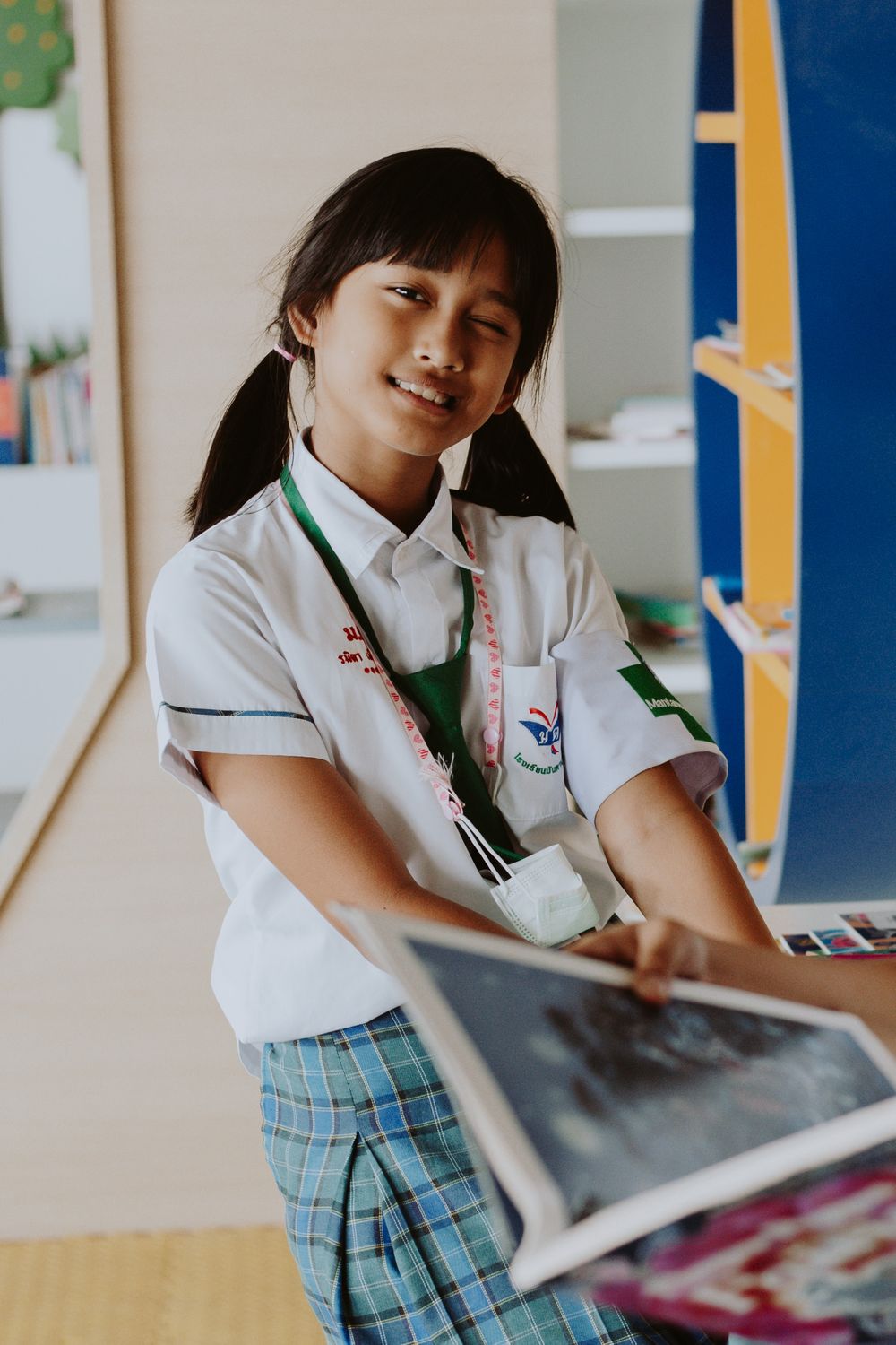 Student in a formal school uniform in a classroom