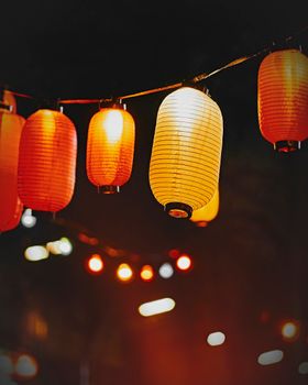 Close-up of illuminated Chinese lanterns hanging at night in Hamburg, Germany.