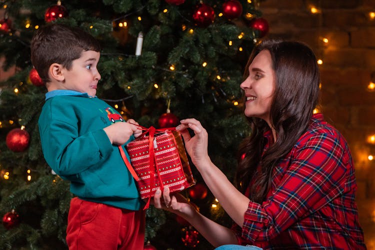 Woman Opening A Present With Her Son