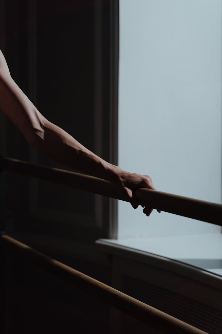 Close-Up Shot Of A Person Holding On A Railing