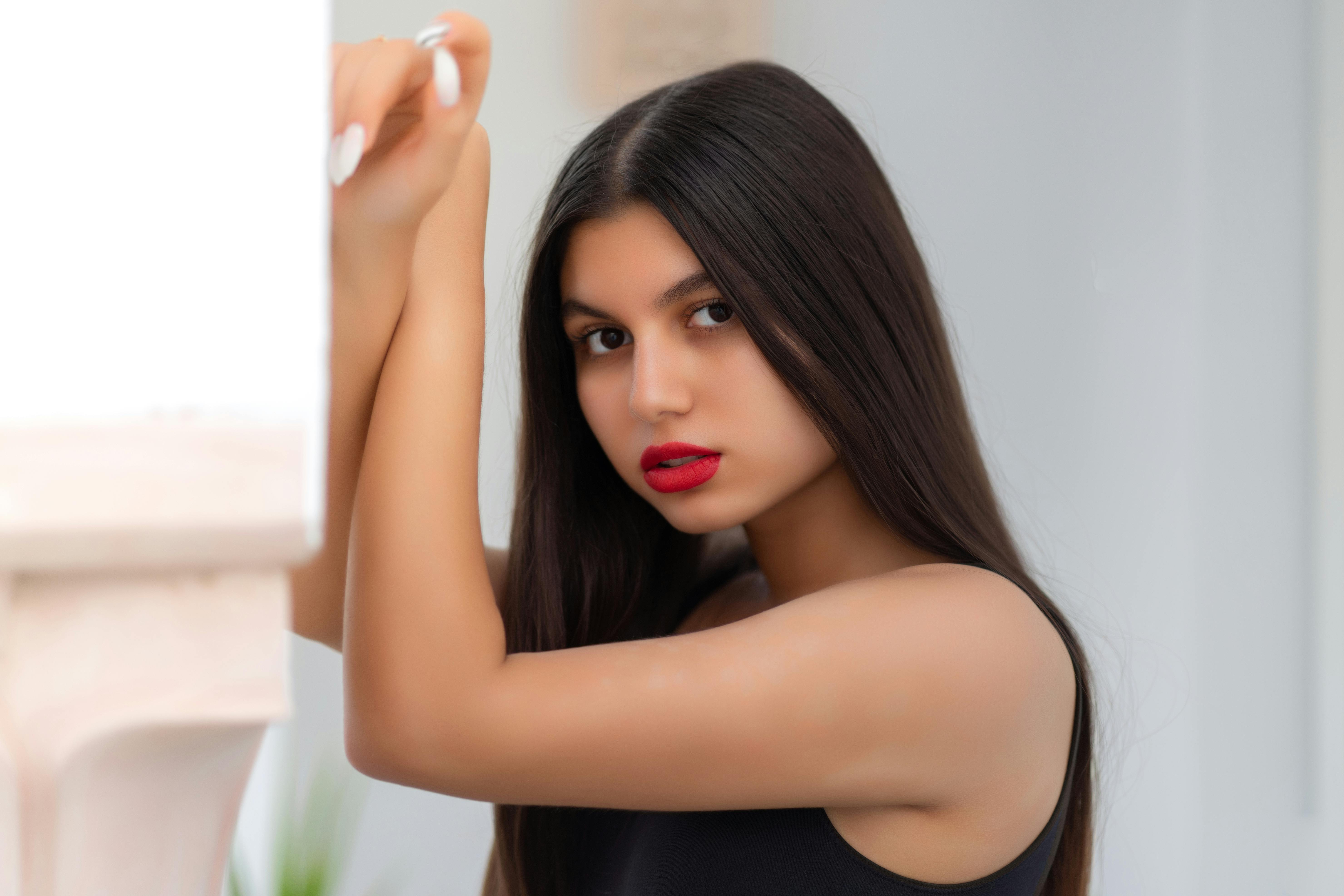 close up shot of an attractive woman in black tank top