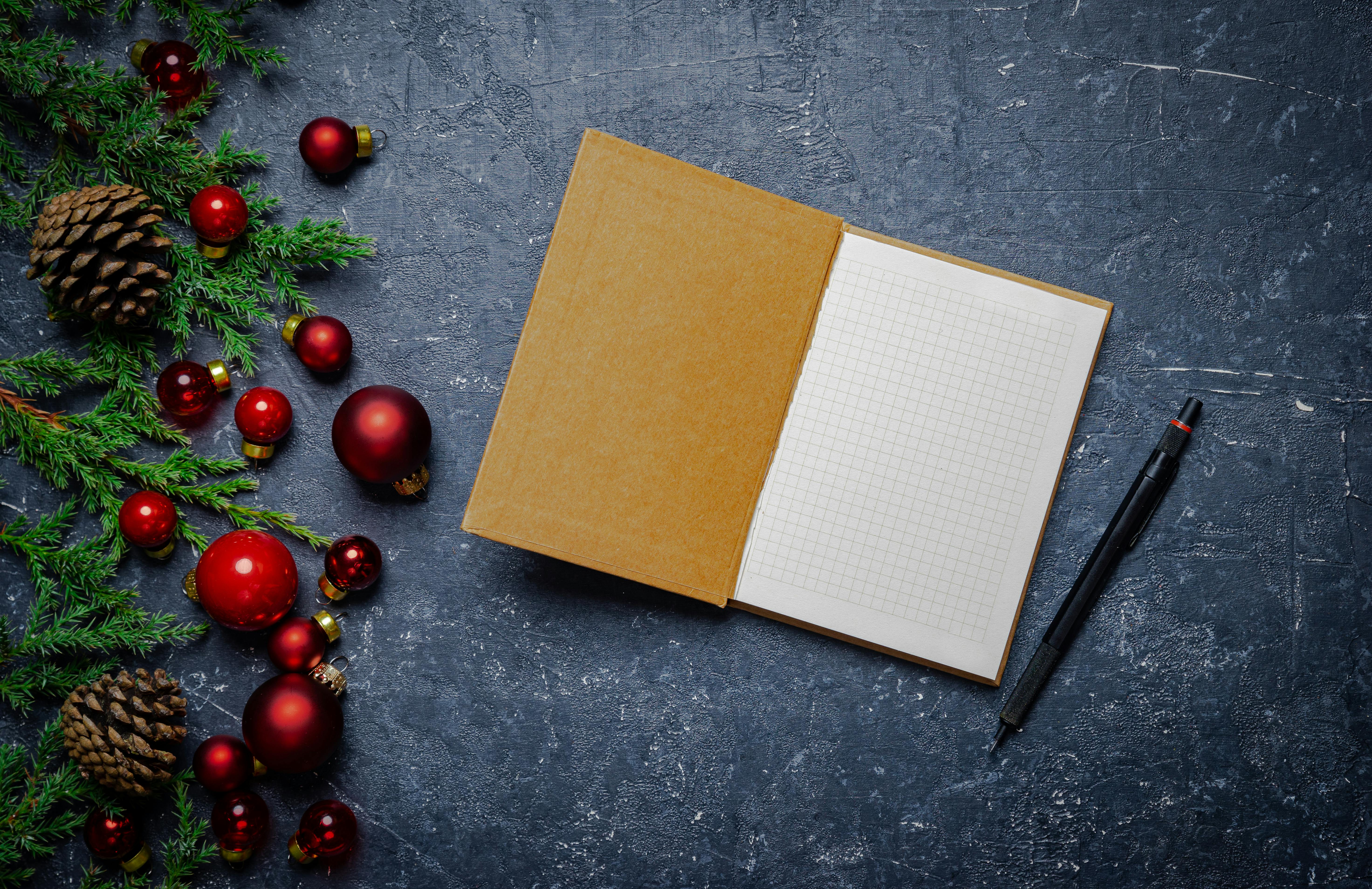 Free Open notebook with Christmas decorations on a concrete surface. Stock Photo
