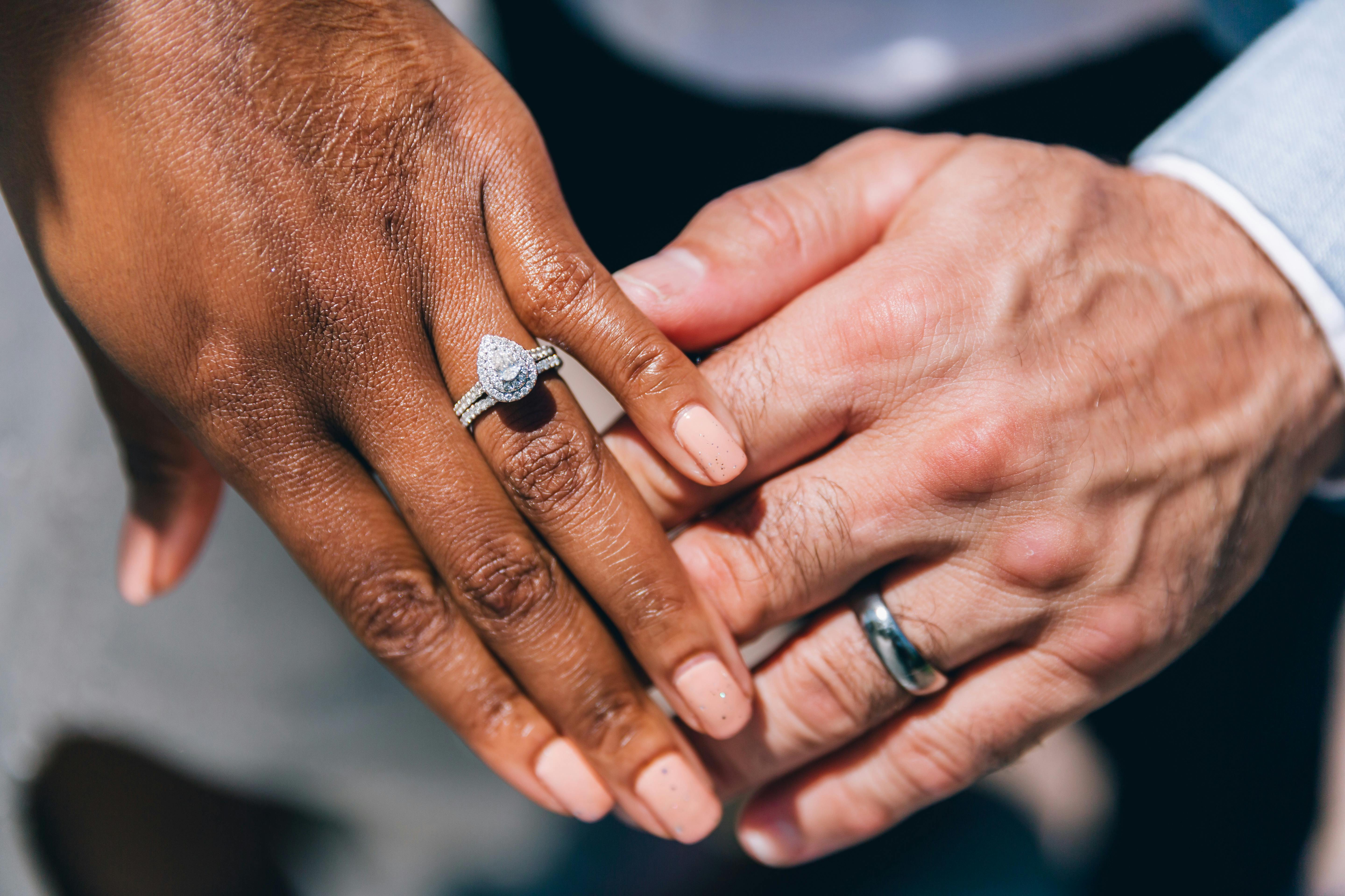 Couple holding hands and showing engagement ring · Free Stock Photo
