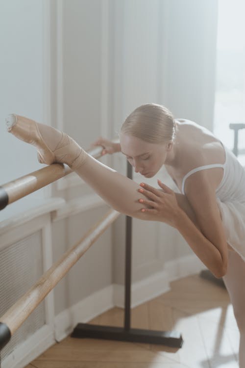 Flexible Ballet Dancer stretching her Leg