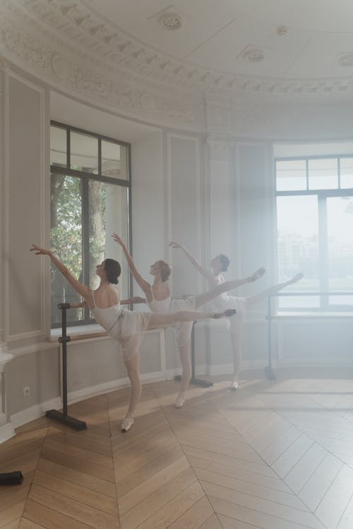 Female Ballet Dancers performing on a Practice Room