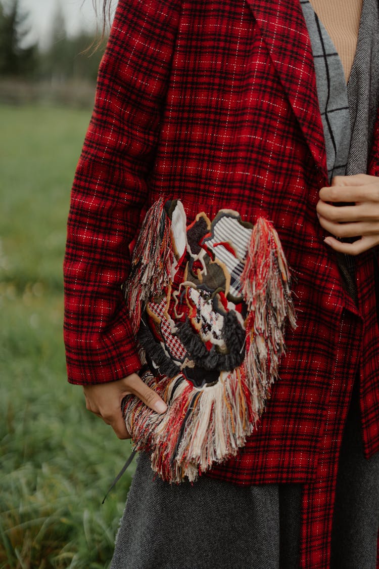 Person In Red Plaid Coat Carrying A Boho Style Bag 