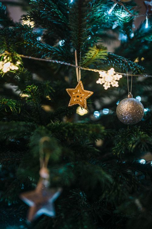 Free Close-up of a decorated Christmas tree with star ornaments and baubles. Stock Photo