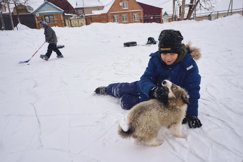 Boys with Ice Skates and Dog Playing Outdoors