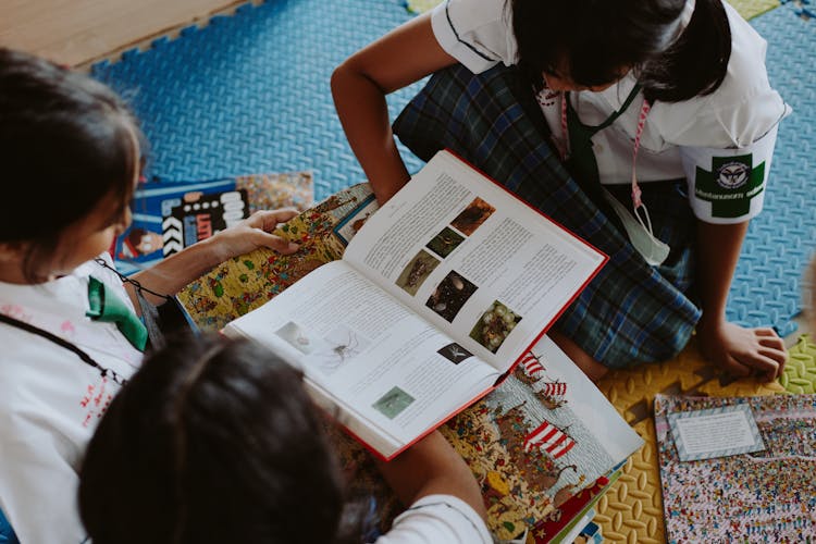 Girls Reading Books Sitting On Floor