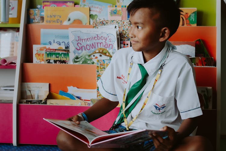 School Boy In Uniform Reading Book