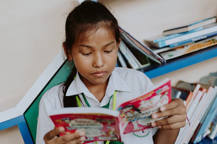 Portrait Of Thai Girl In School Uniform Reading Book