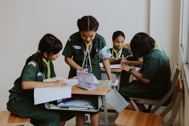 Thai School Girls In Uniforms Studying By Desks