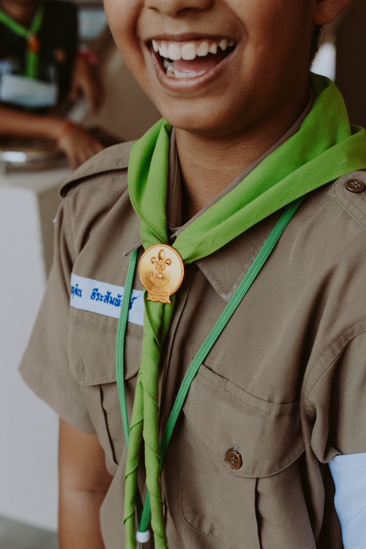 Smiling Child Wearing A Scout Uniform