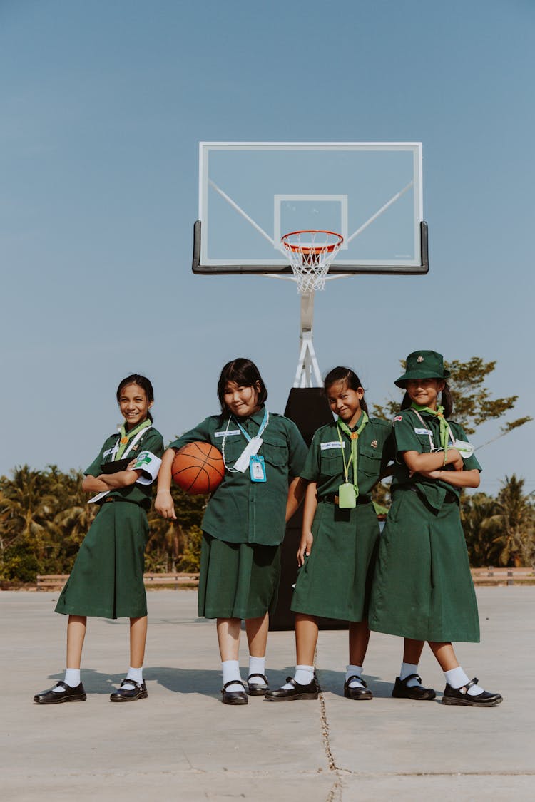 A Group Of Students Standing On A Basketball Court