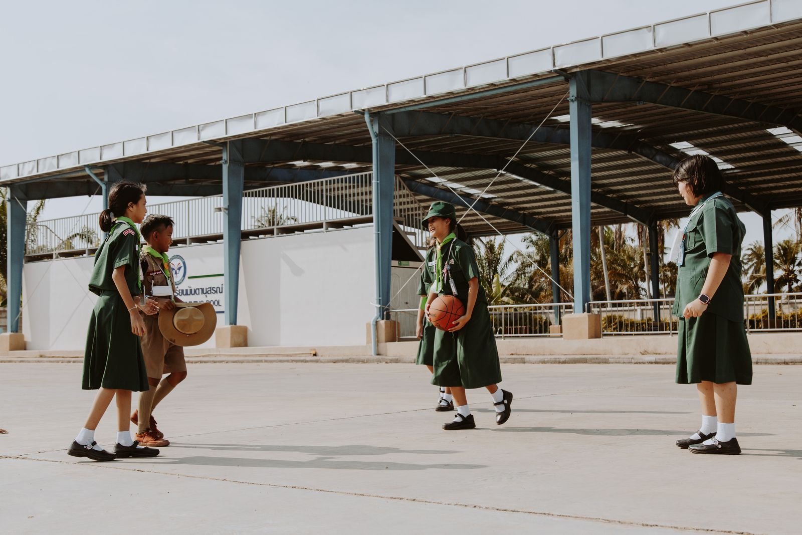 Students playing basketball on a school court