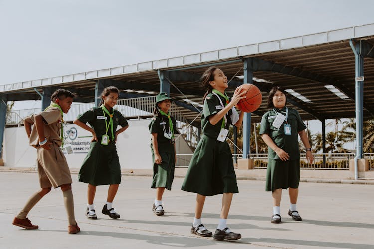A Group Of Students Playing Basketball