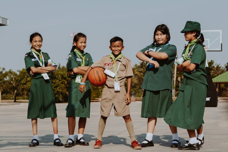 A Group Of Students Standing On A Basketball Court