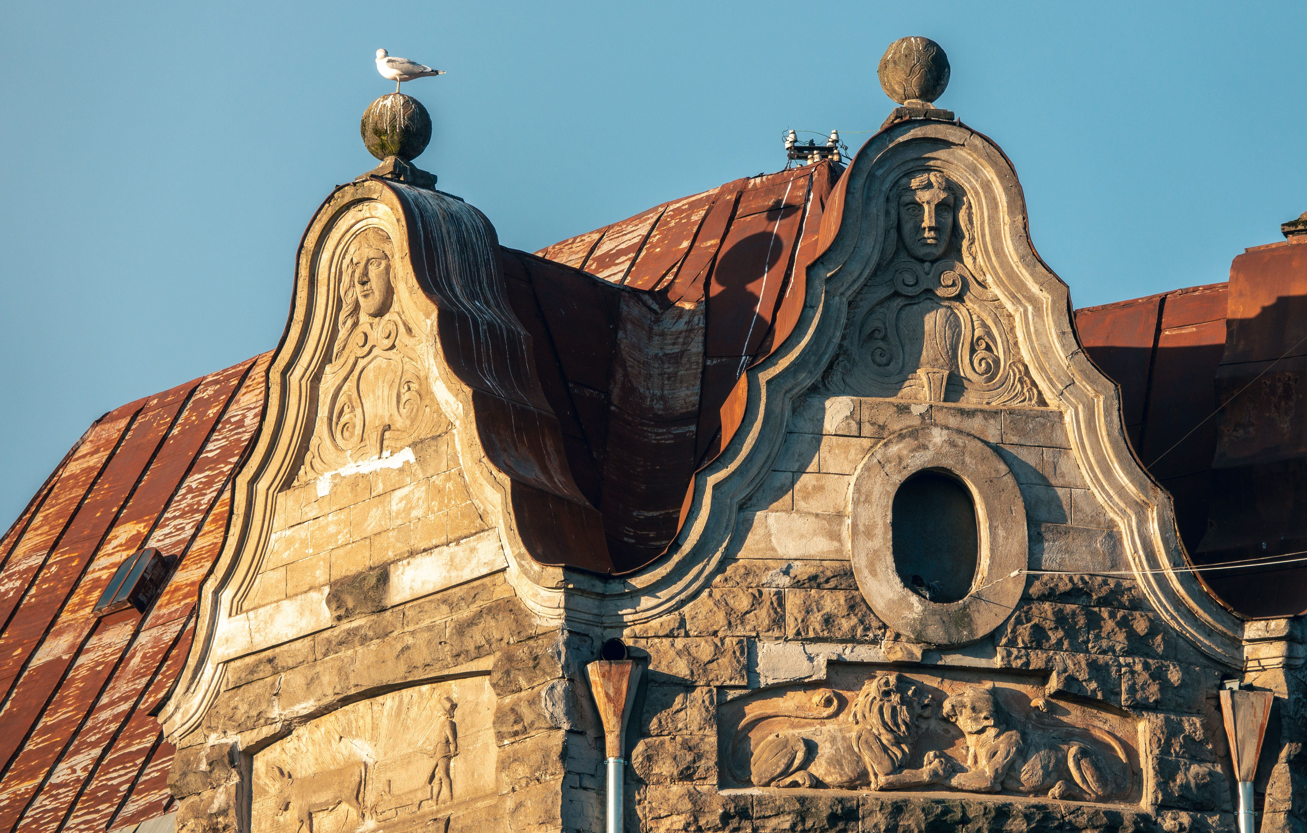Intricate Art Nouveau facade with sculptures in Riga, Latvia, under a clear sky.