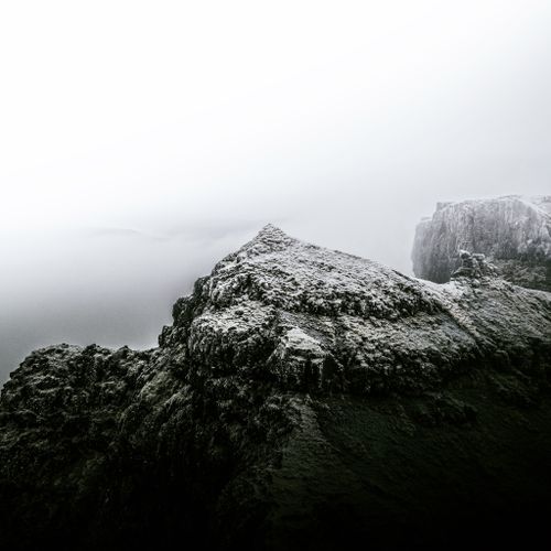 Free Stunning monochrome Scottish mountain landscape with dramatic cliffs in fog. Stock Photo