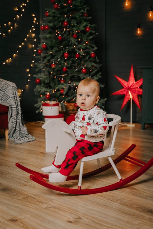 A Cute Baby Boy Sitting on a Rocking Chair