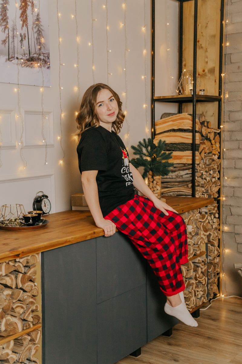 Woman in festive pajamas in a cozy winter setting