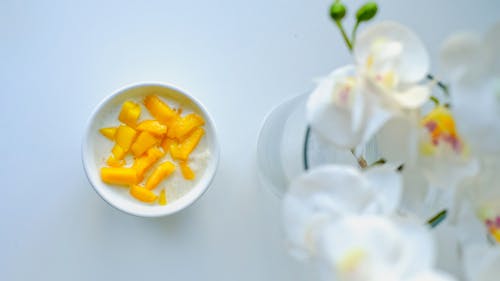 Free Yogurt with Mango Next to Orchid  Stock Photo