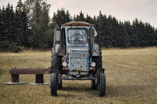 A Blue Tractor on a Grassy Field
