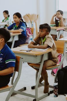 Students attentively listening in a classroom in Thailand, promoting education and learning.