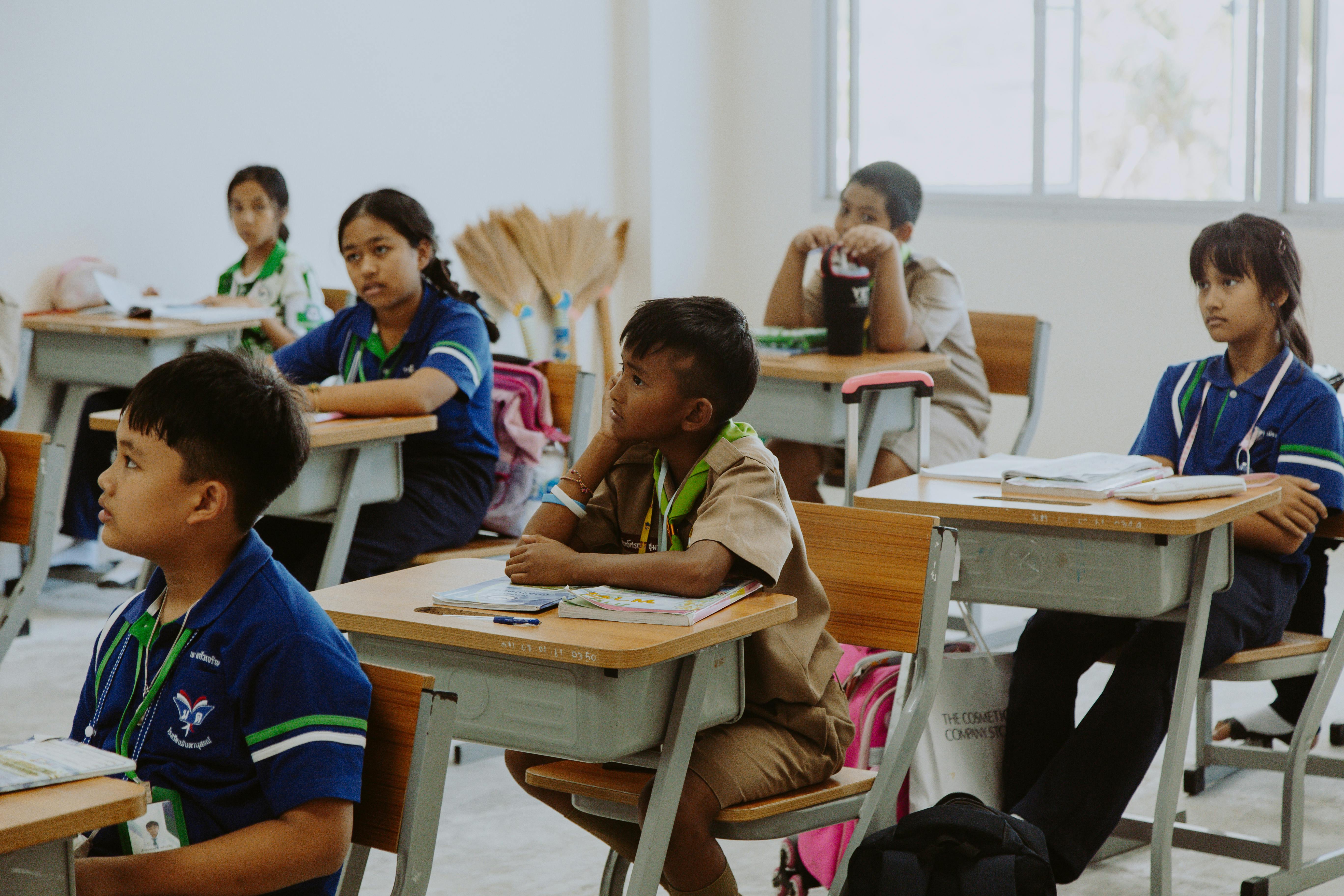 Free Children Sitting on School Chairs Stock Photo