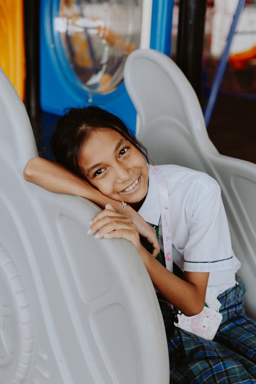 Free A Young Girl in School Uniform Smiling Stock Photo