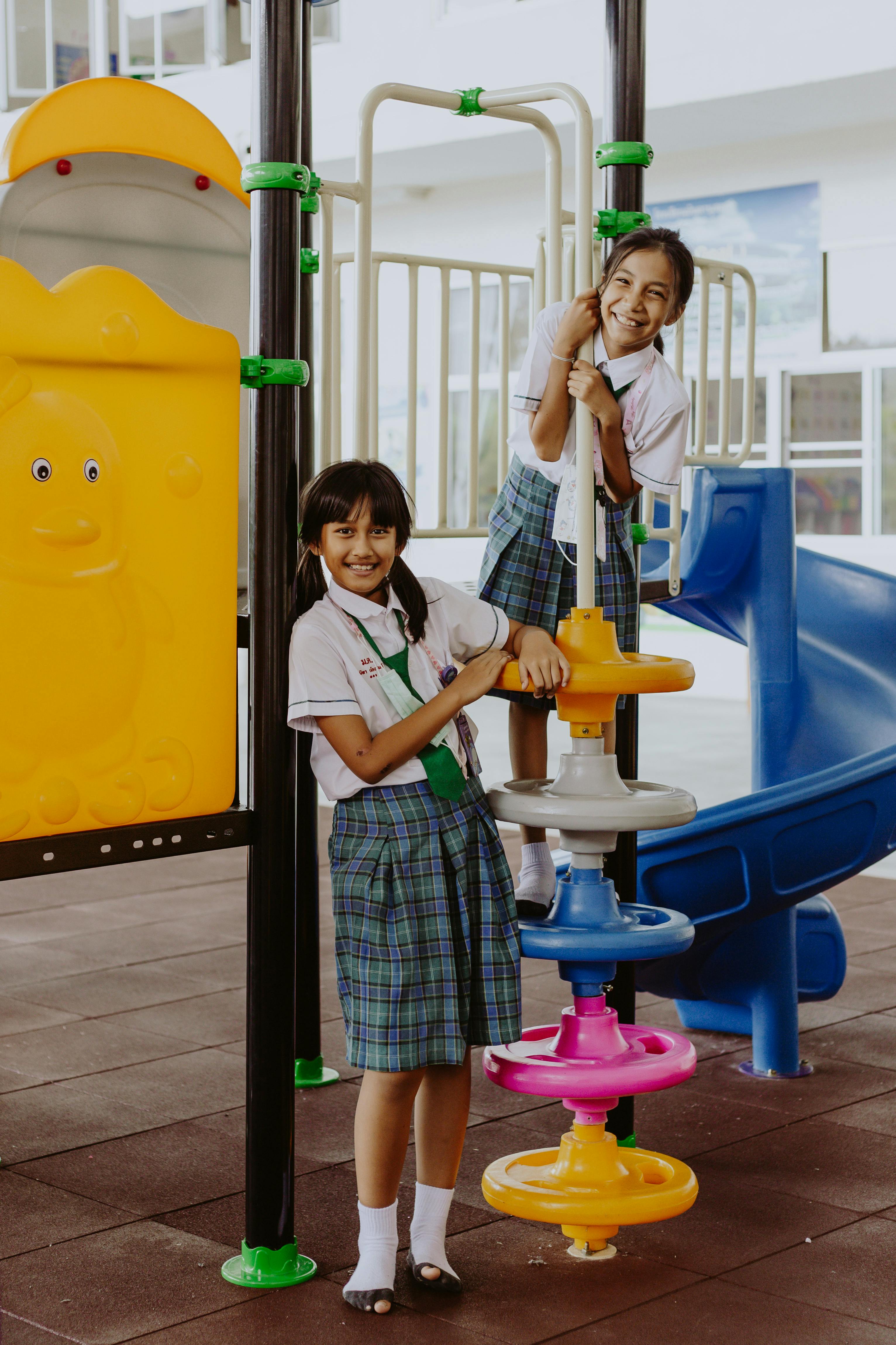 Four children playing in a playground - Stock Image - F033/7416 - Science  Photo Library