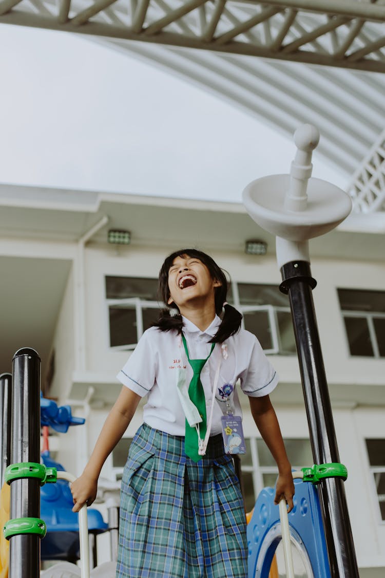 Girl In School Uniform Laughing In School Gymnasium