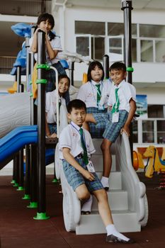 Children in school uniforms enjoying fun at the playground.