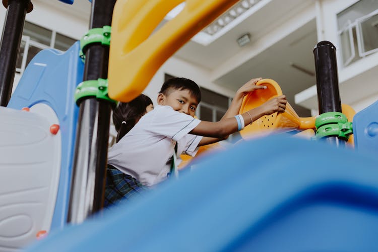 Boy In School Uniform Playing In School Gymnasium