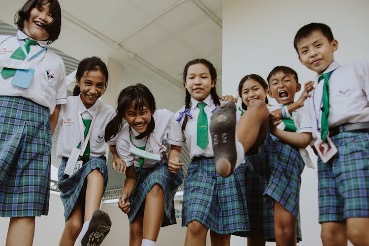 Smiling Boys And Girls In School Uniforms