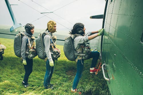 Smiling Skydivers Boarding into Plane