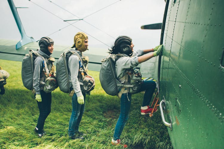 Smiling Skydivers Boarding Into Plane