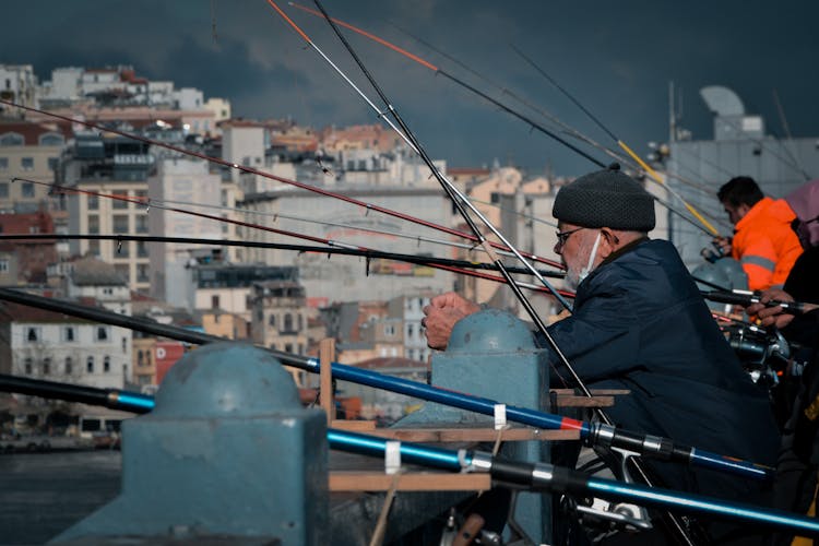 A Man Fishing On A Bridge