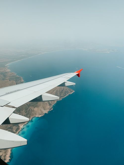 Free View from airplane over the beautiful coastline of Ibiza, Spain, with clear blue seas. Stock Photo
