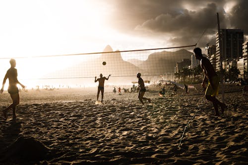 Group of People Playing Beach Volleyball