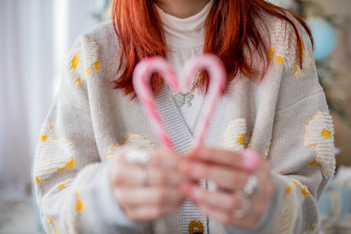 Mid Section of Woman Holding Candy Canes