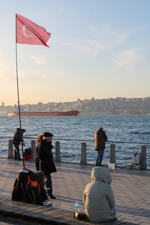 Free People on Promenade on Seashore Stock Photo