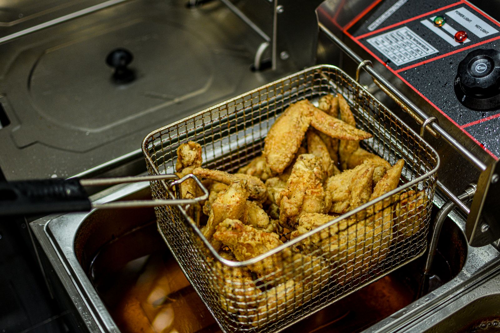 Air fryer basket with crisp chicken pieces